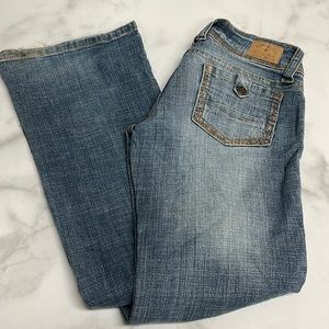 Hydraulic Low Rise Tabbed Pocket Distressed Boot Cut Stretch Denim Jeans 1/2